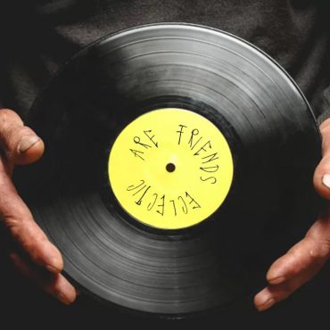 image of dj holding vinyl record for eclectic radio show