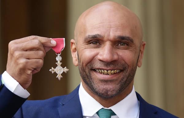 Picture of Goldie holding his MBE