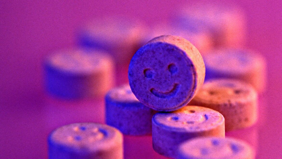 Ensuring Festival Safety: The Fight for On-Site Drug Testing: pink wallpaper of ecstasy tablets.